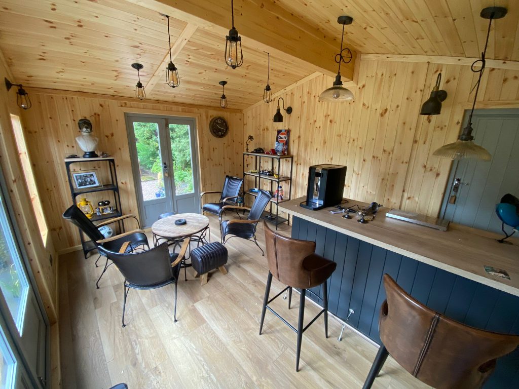 CONTEMPORARY SUMMERHOUSE WITH A GLULAM BEAM AND A BAR WITH DROP DOWN LIGHTS BY LANCASHIRE SUMMERHOUSES